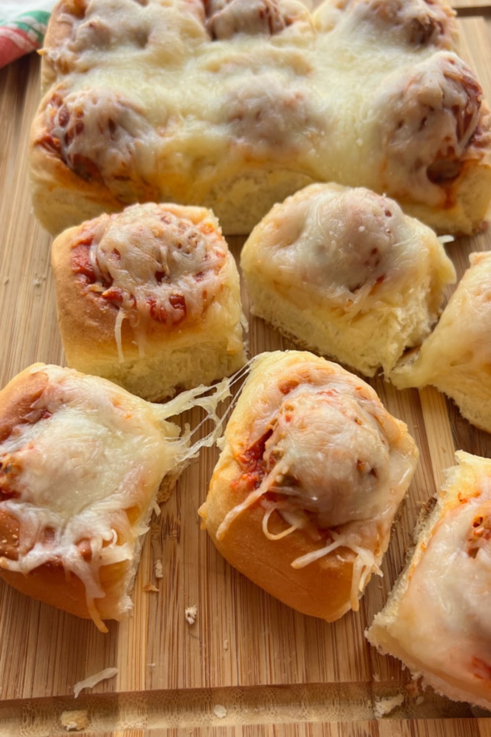 Hawaiian roll meatball sliders on a cutting board,