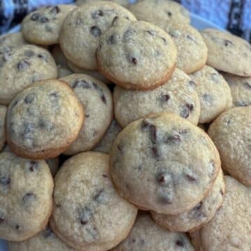 A pile of bite-sized chocolate chips cookies on a plate